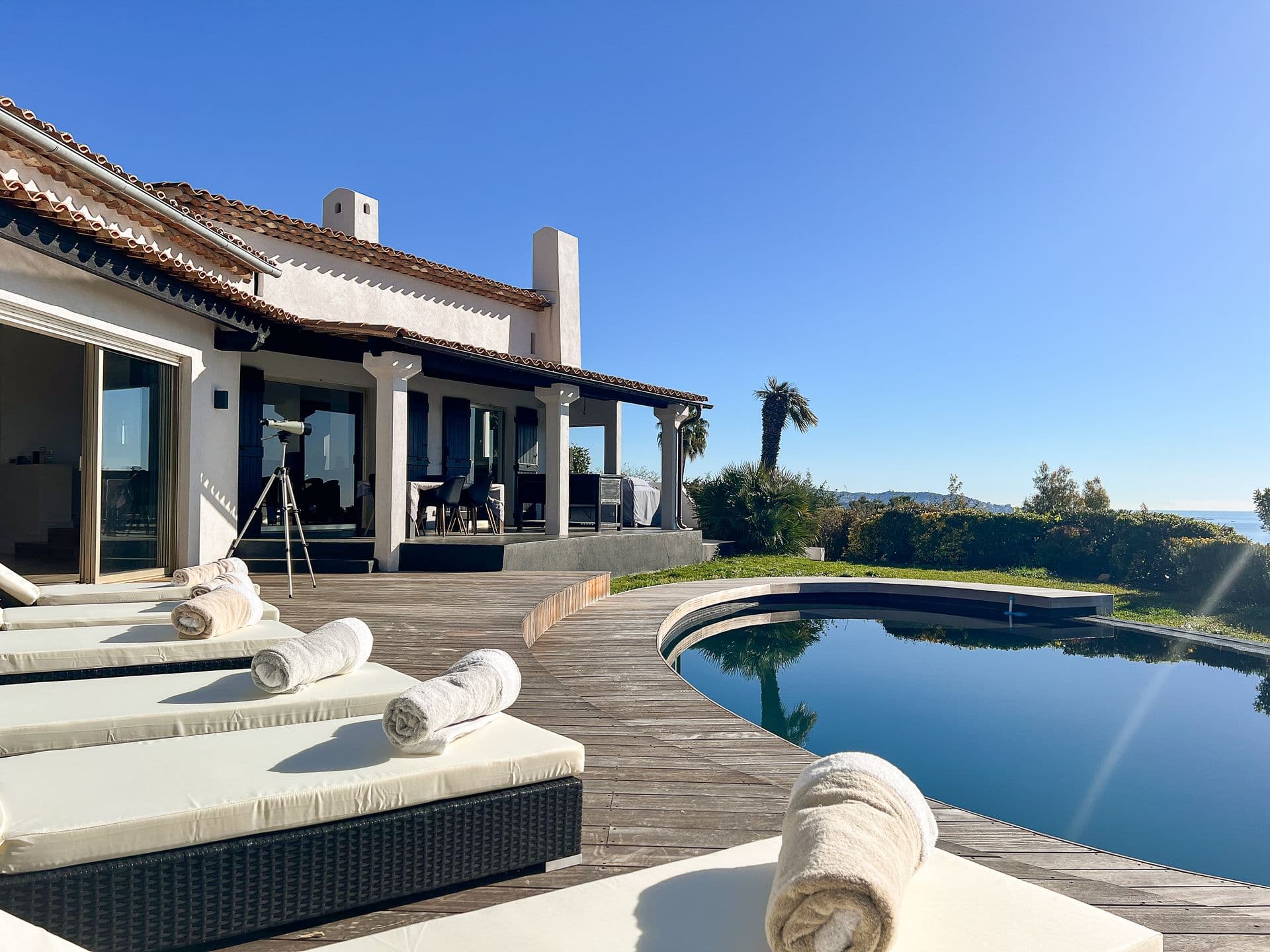 Pool deck with sun loungers at Southern Beauty villa