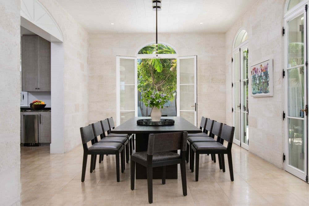 Formal dining room seating twelve with stone walls at Sea Breeze Estate