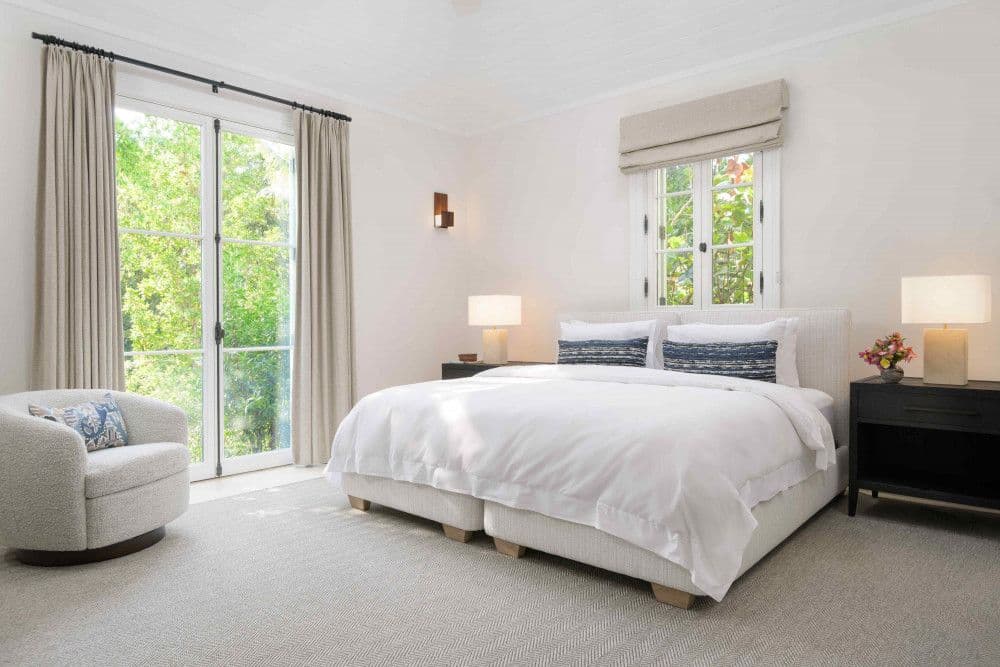 Guest bedroom with a king bed and garden views at Sea Breeze Estate
