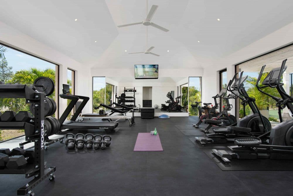 Fully equipped home gym with Peloton bikes and free weights at Sea Breeze Estate
