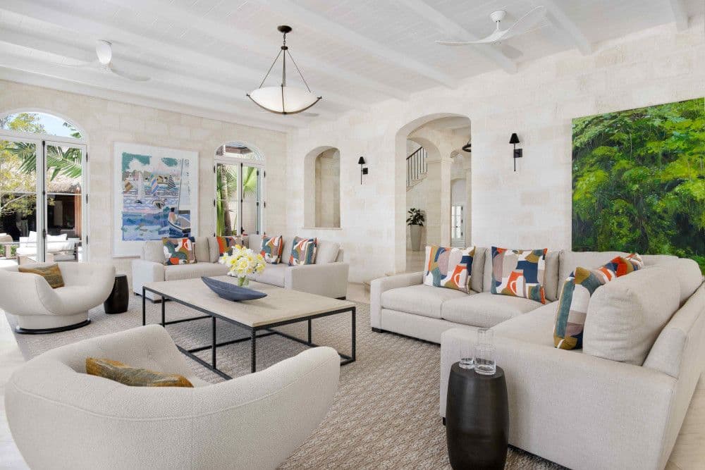 Second living room with coral-stone walls and vaulted ceiling at Sea Breeze Estate
