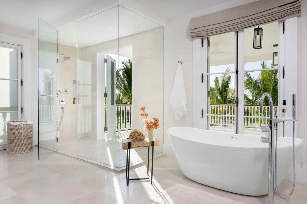 Master en-suite with a freestanding tub and walk-in shower opening to a balcony at Sea Breeze Estate