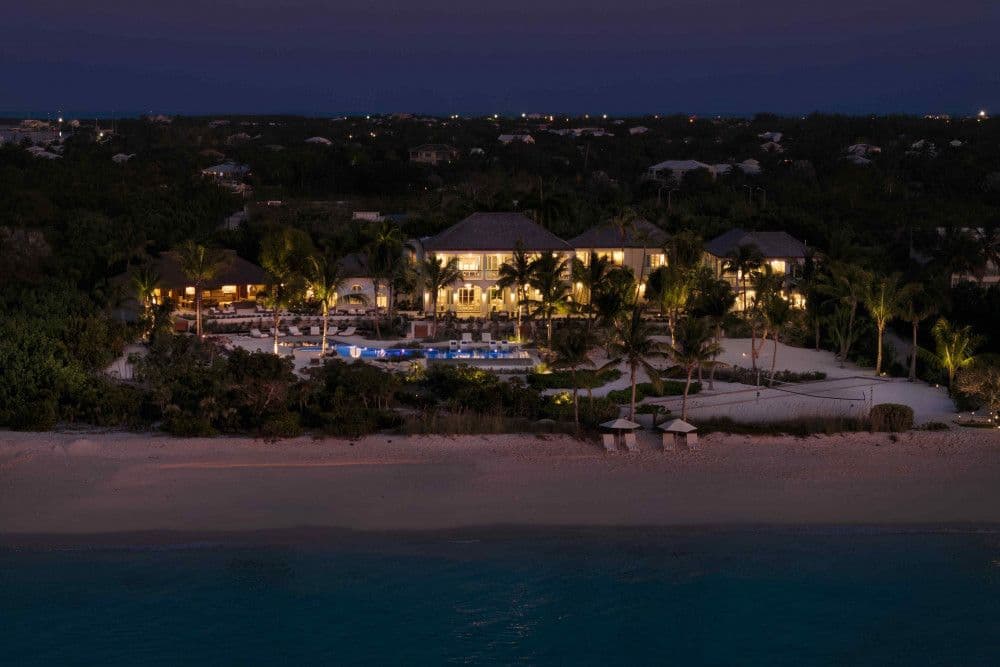 Sea Breeze Estate lit up on the beach at night, Providenciales