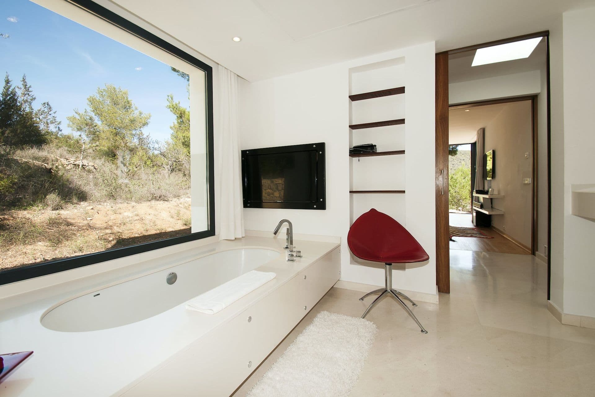 Bedroom suite with a built-in bathtub set into the room beside the bed