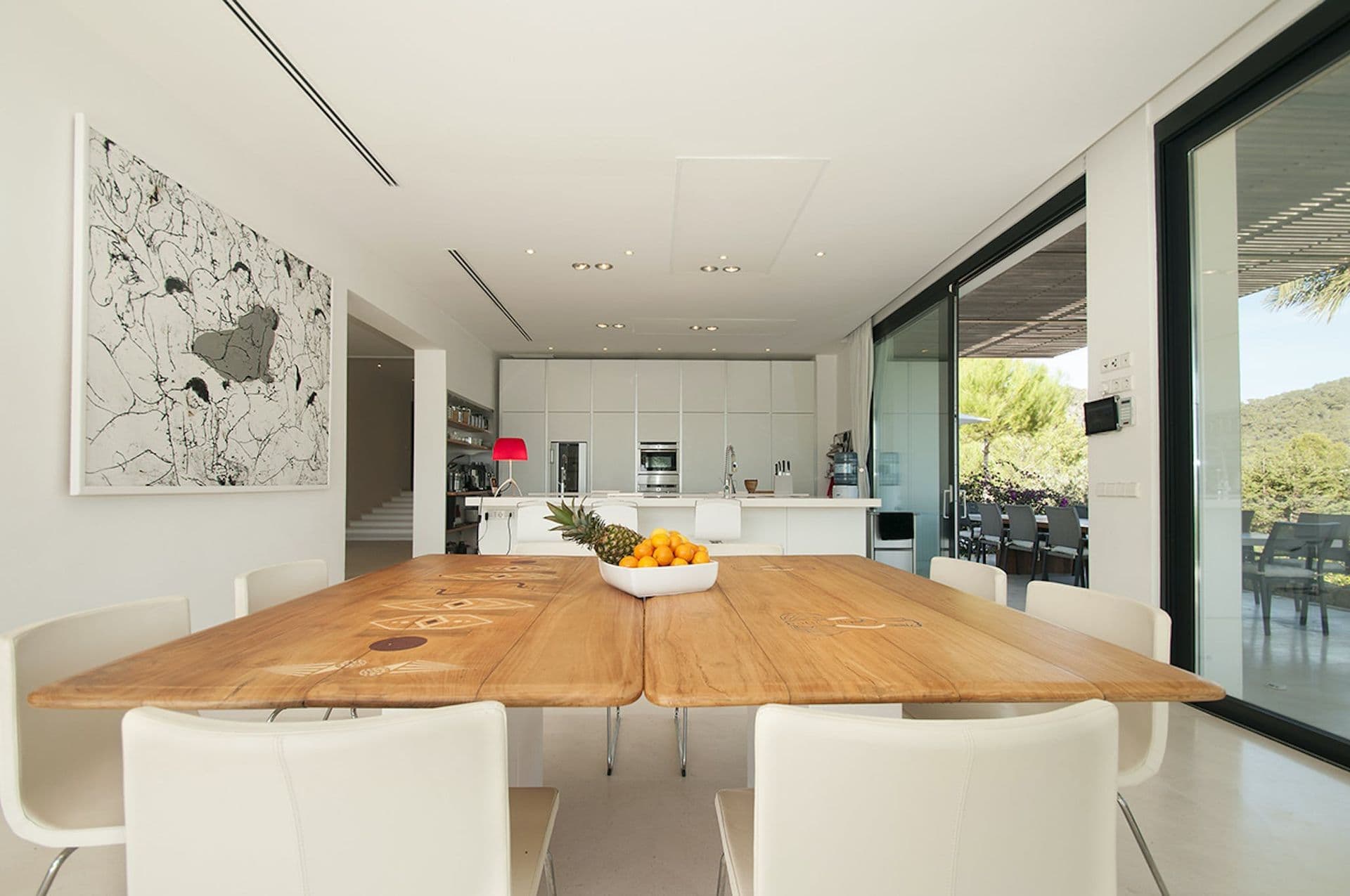 Indoor dining area with solid wood table seating eight beside the kitchen
