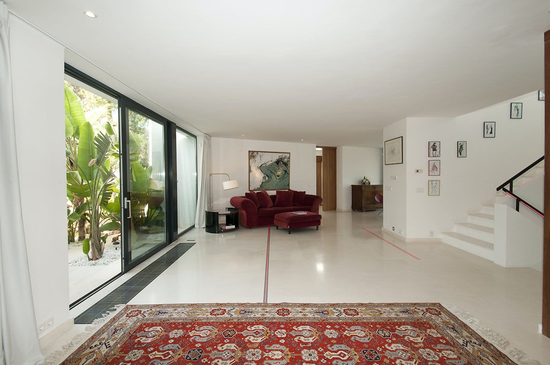Entrance hall with polished stone floor and antique patterned rug