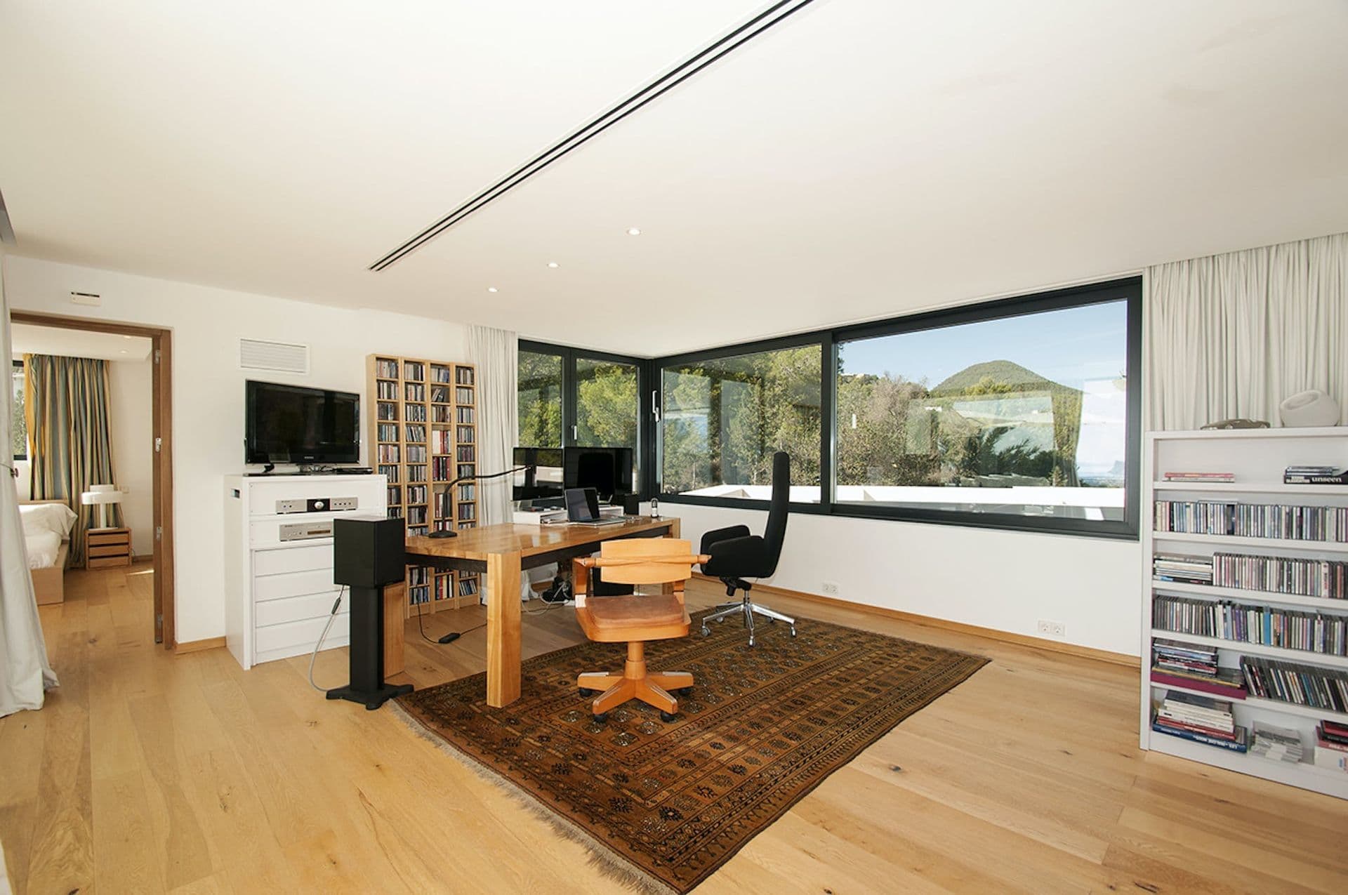 Home office and study nook with wooden desk and built-in bookshelves