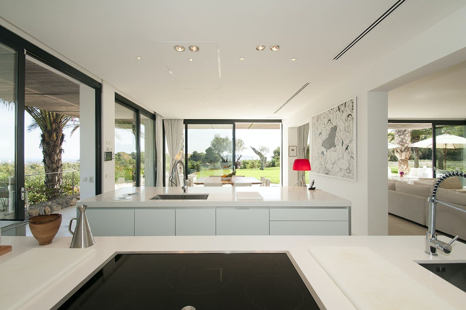 Close-up of the kitchen worktop and induction hob with garden views beyond