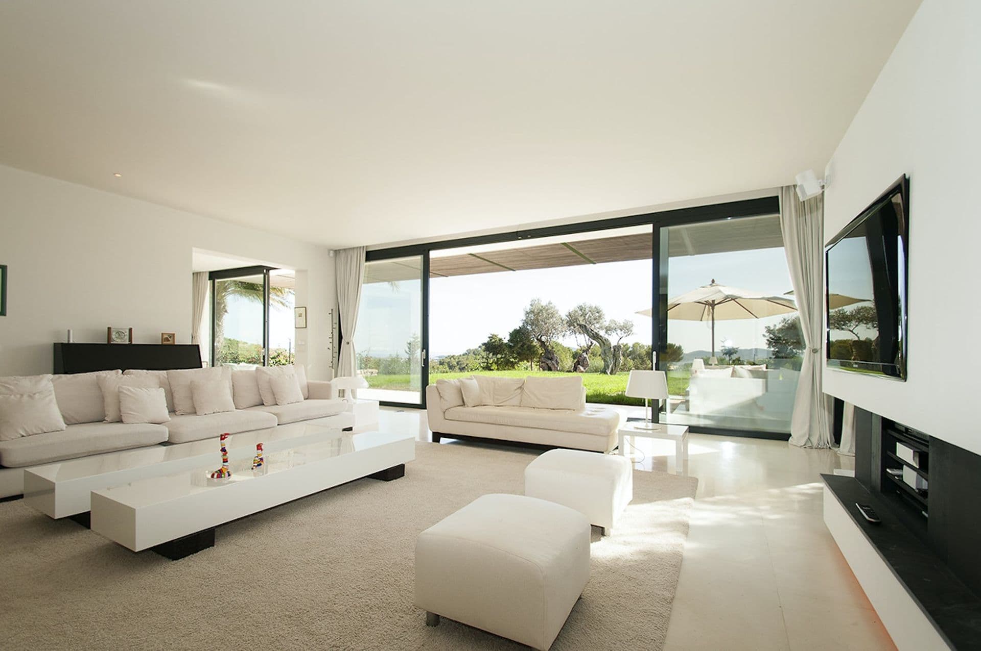 Bright white living room with sliding glass doors opening onto the garden