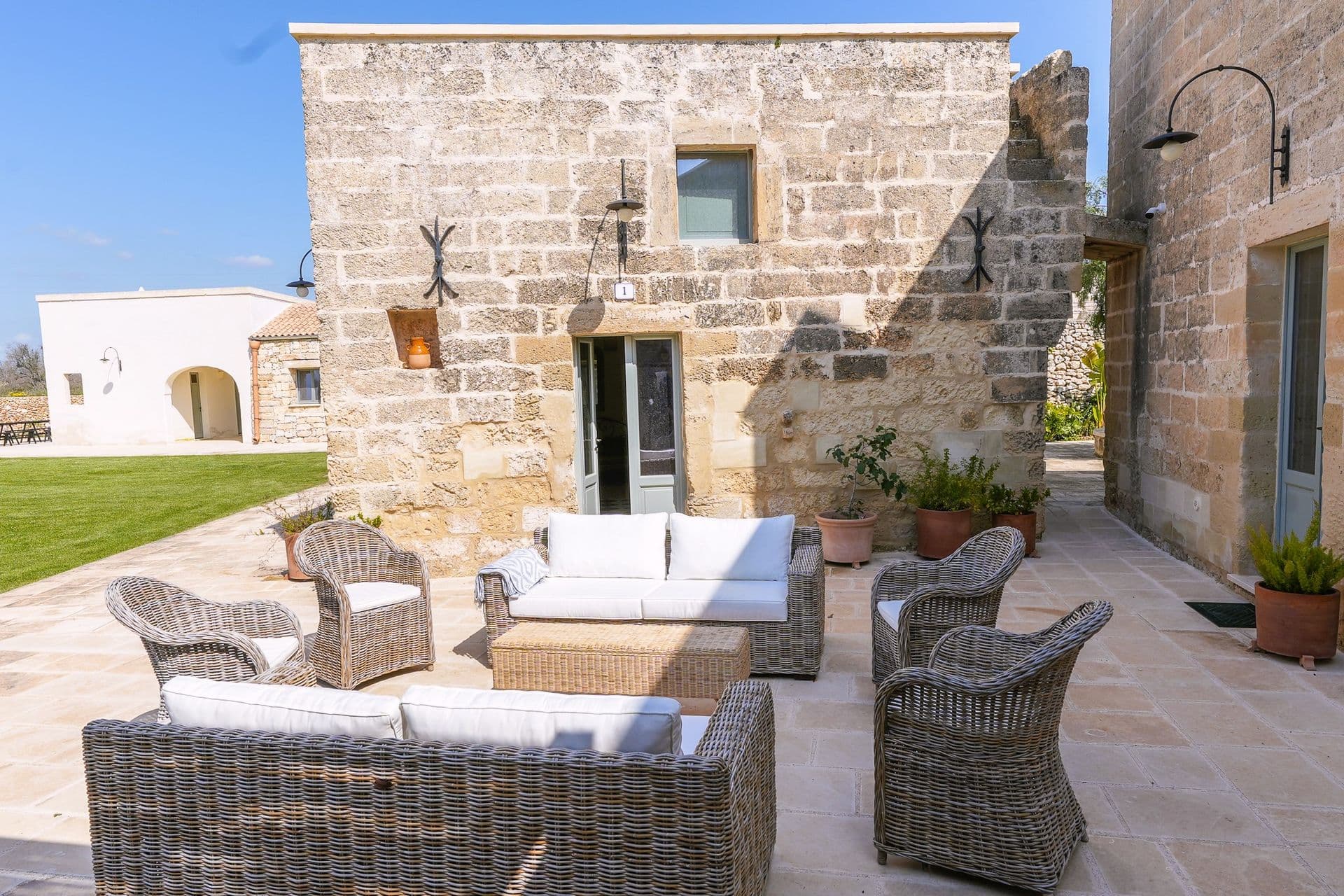 Stone courtyard lounge seating at Puglian Farmhouse
