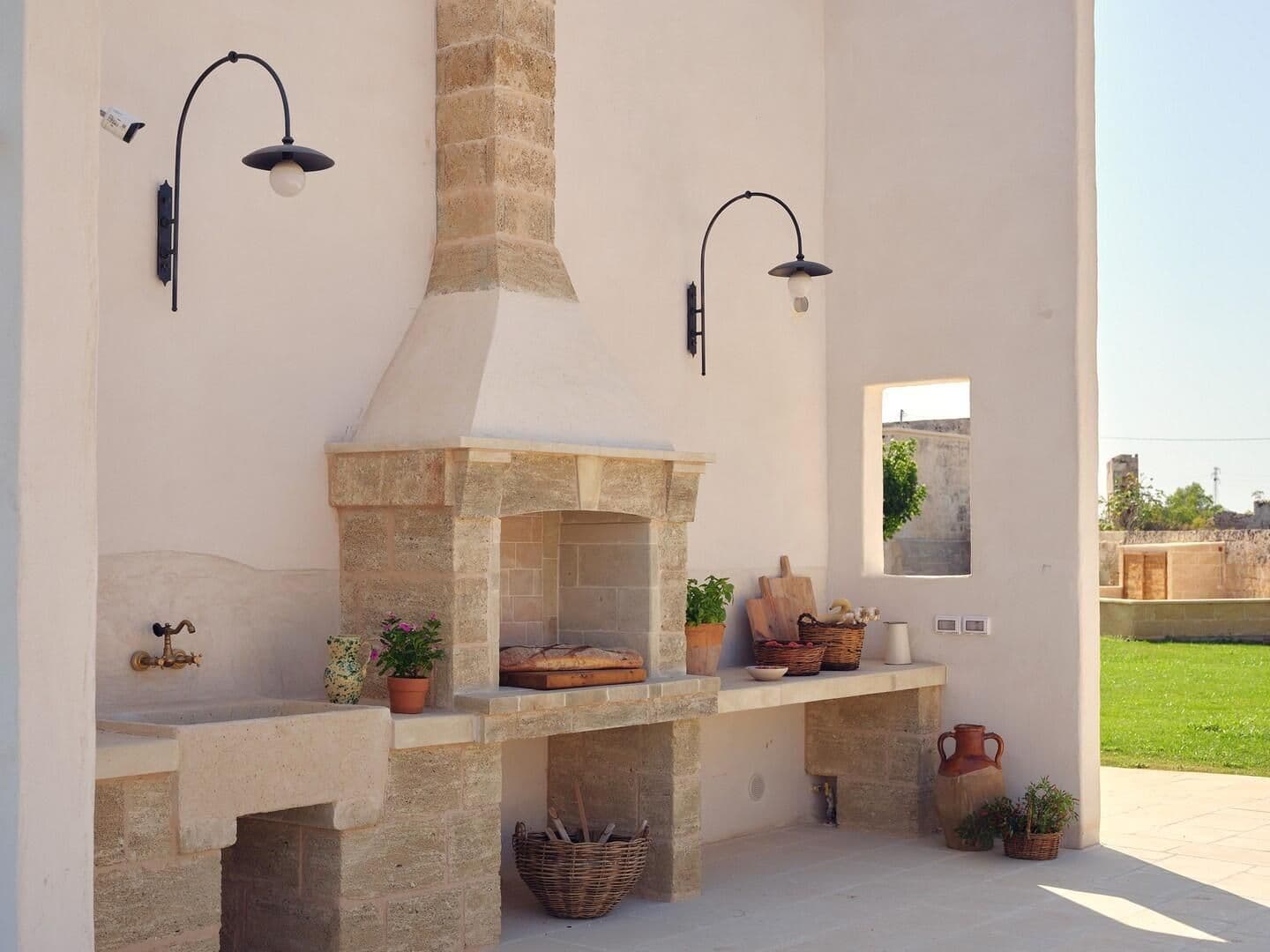 Stone outdoor kitchen and grill area at Puglian Farmhouse