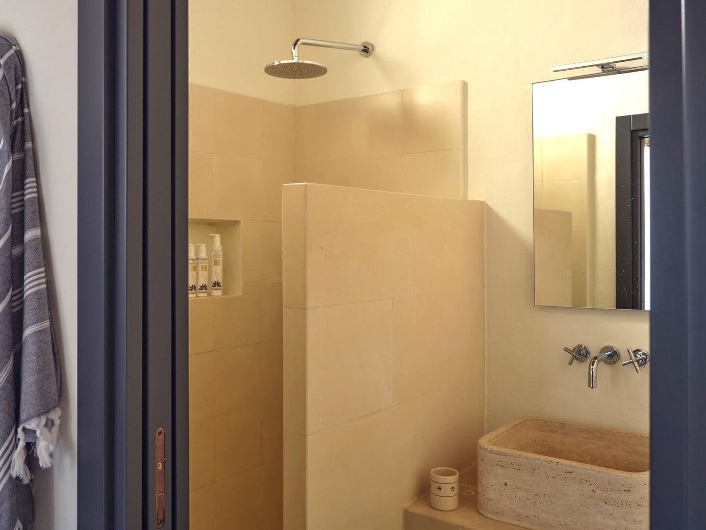 Stone-walled walk-in shower at Puglian Farmhouse