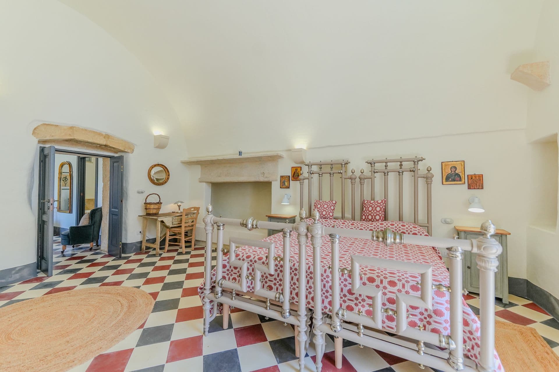 Twin bedroom with iron bed frames and checkered floor at Puglian Farmhouse