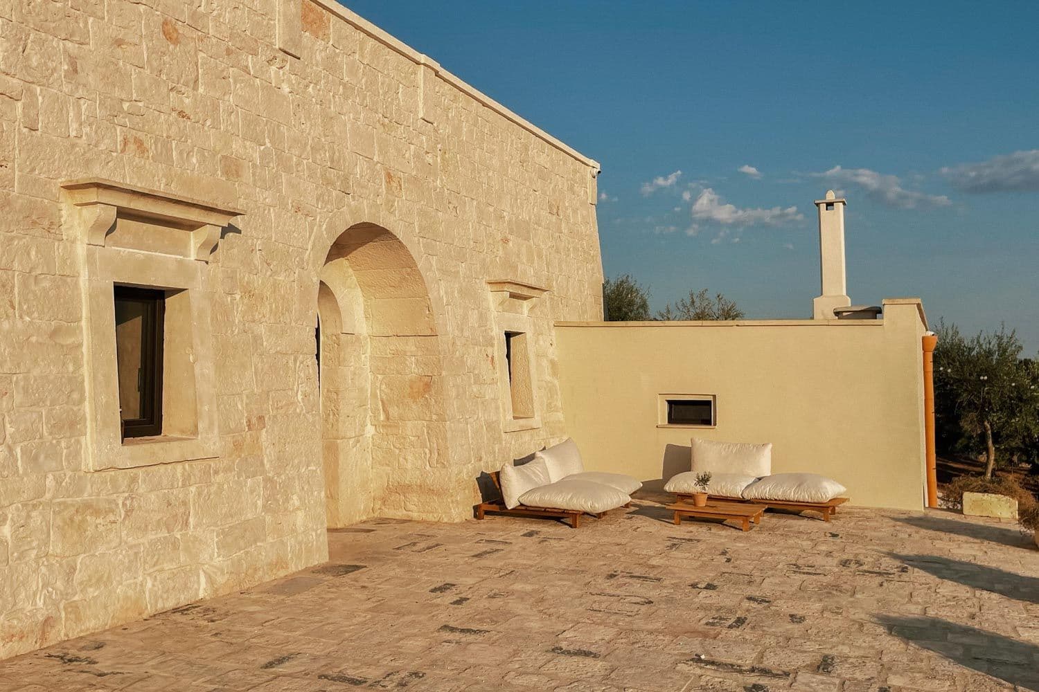 Villa Lucantu terrace lounge area with stone arches and seating, Cisternino, Puglia, Italy