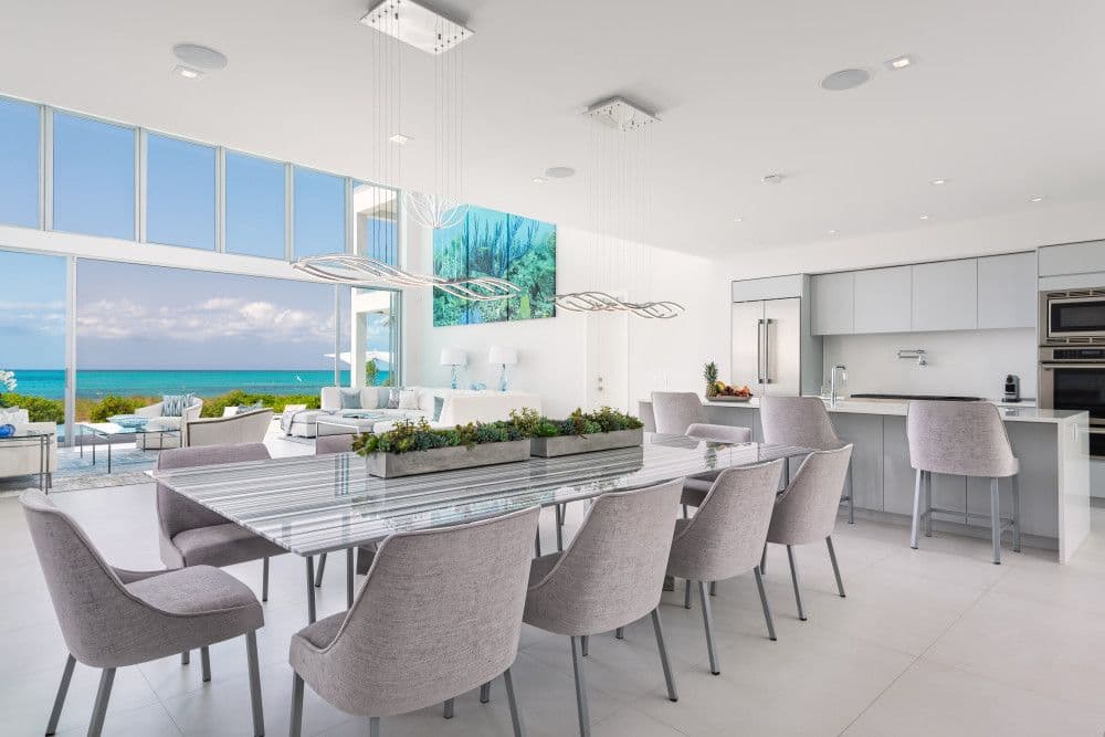 Open-plan dining area for ten beside the kitchen with ocean views