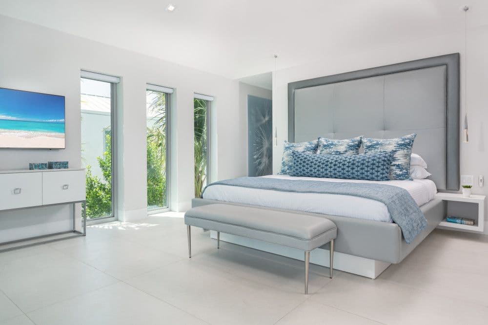 Guest bedroom with a king bed and garden-view windows at Seaclusion
