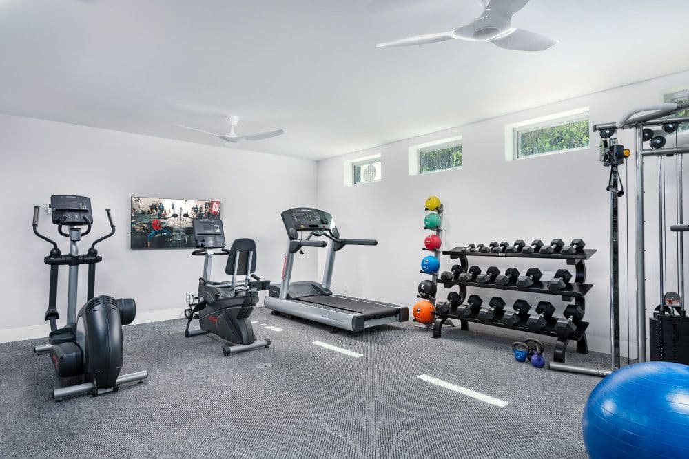 Home gym with cardio machines and free weights at Seaclusion