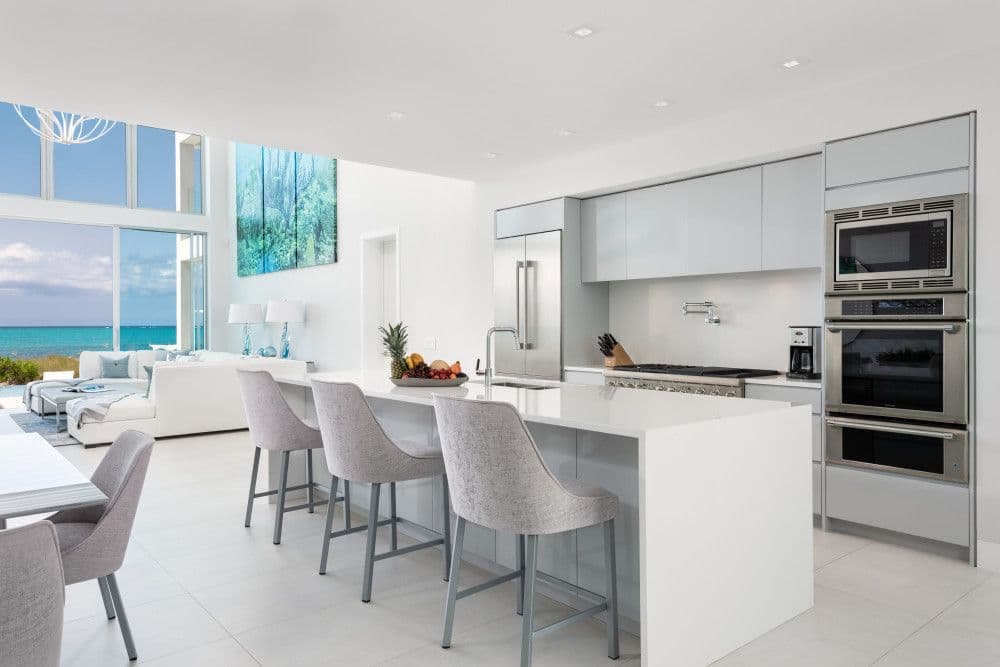 Modern kitchen with an island, bar seating and stainless appliances at Seaclusion