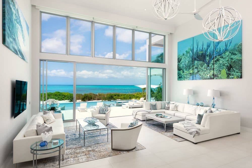 Double-height living room with floor-to-ceiling glass and ocean views