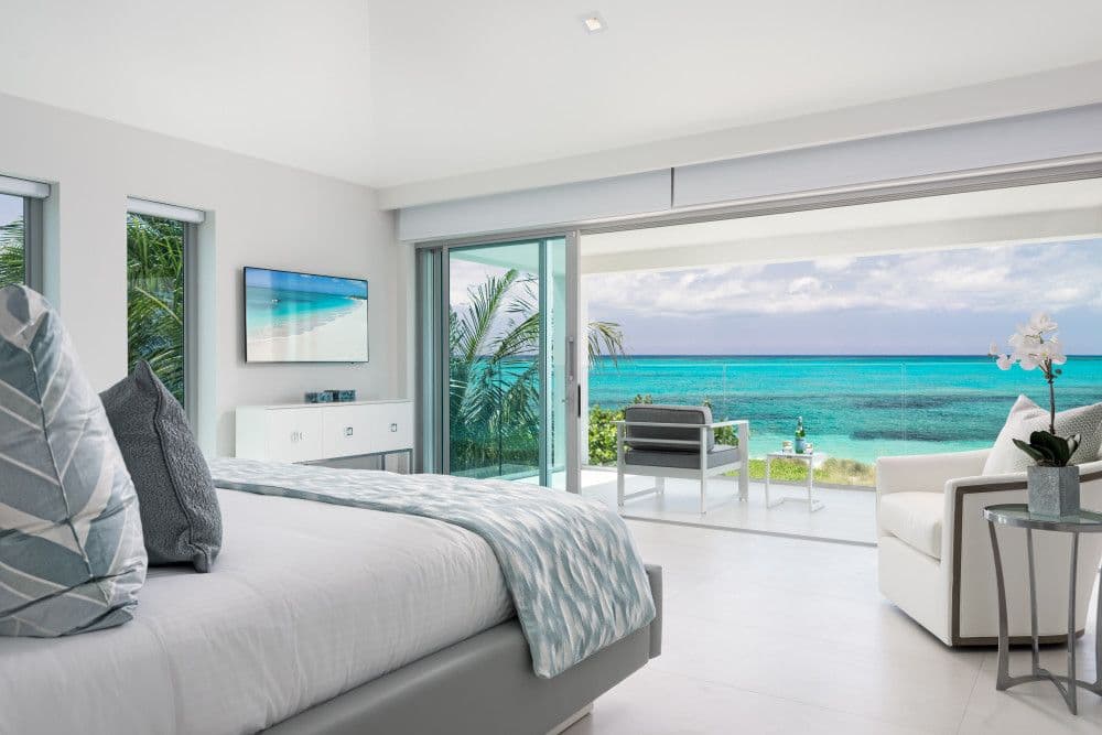 Master bedroom opening to a private terrace with ocean views
