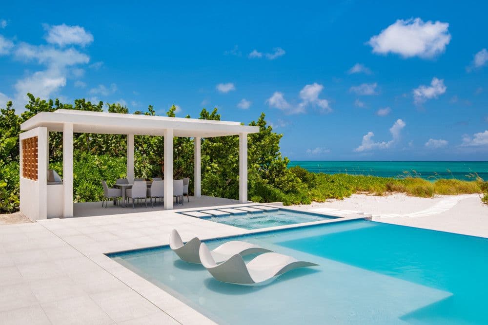 Beachfront pool and spa with a dining pavilion and ocean views at Seaclusion