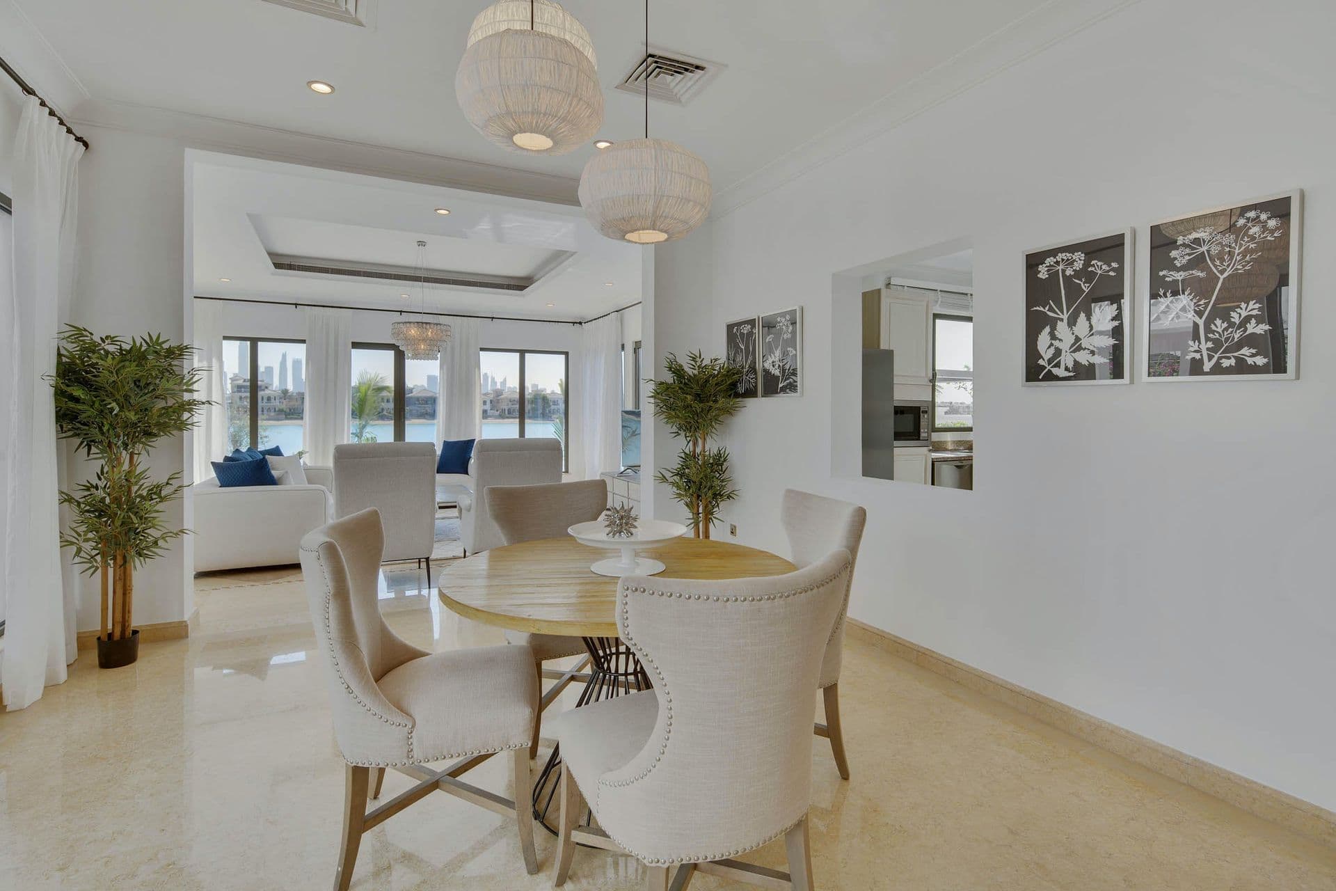 Casual dining nook with a round table and upholstered chairs beside the kitchen.