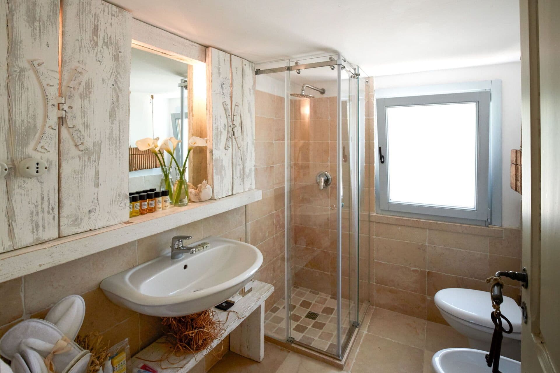 Ensuite bathroom with a glass walk in shower and mirrored vanity at Mediterranean Sunhouse