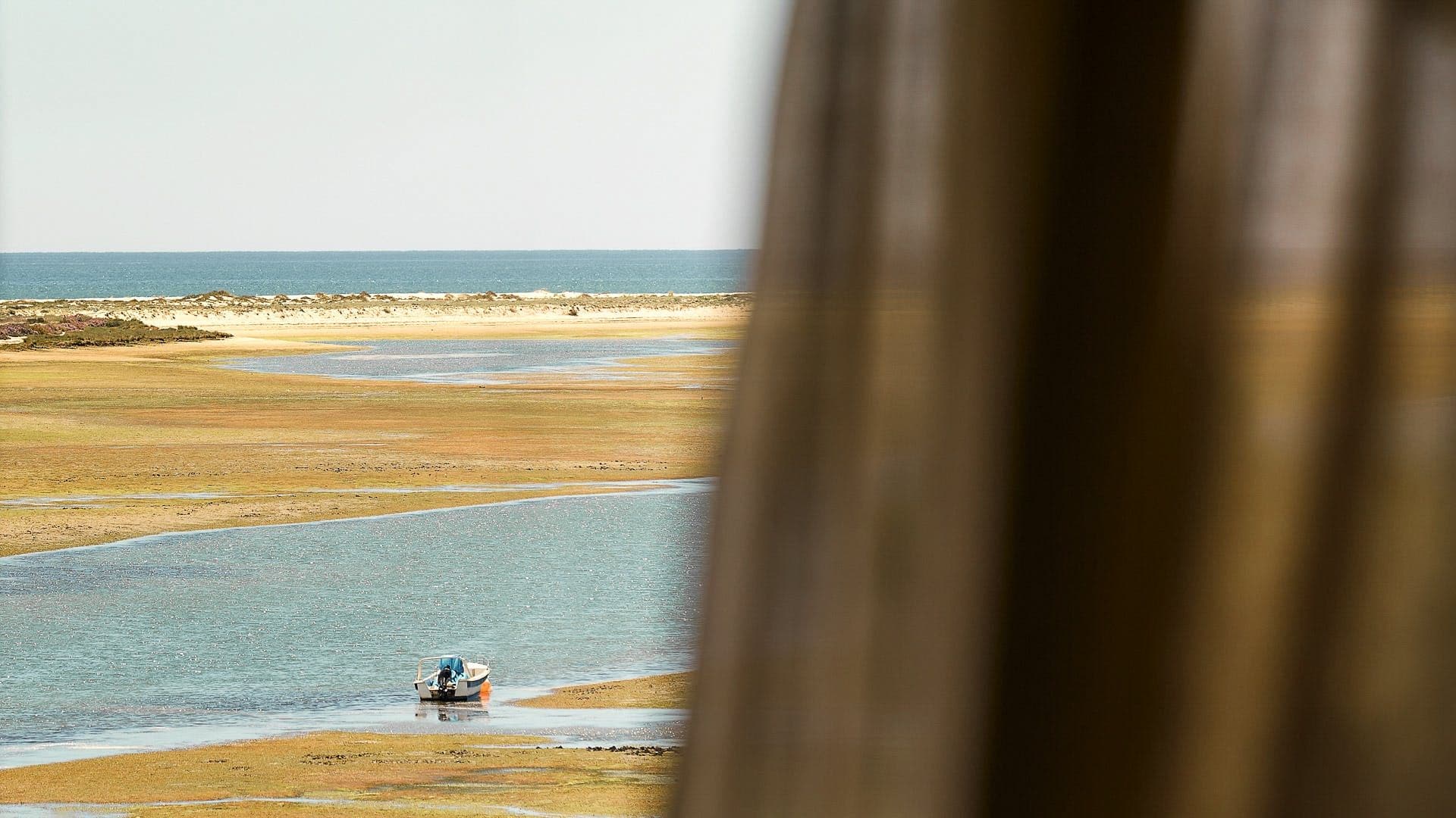 Fishing boats resting on the tidal flats of the Ria Formosa lagoon near Tavira