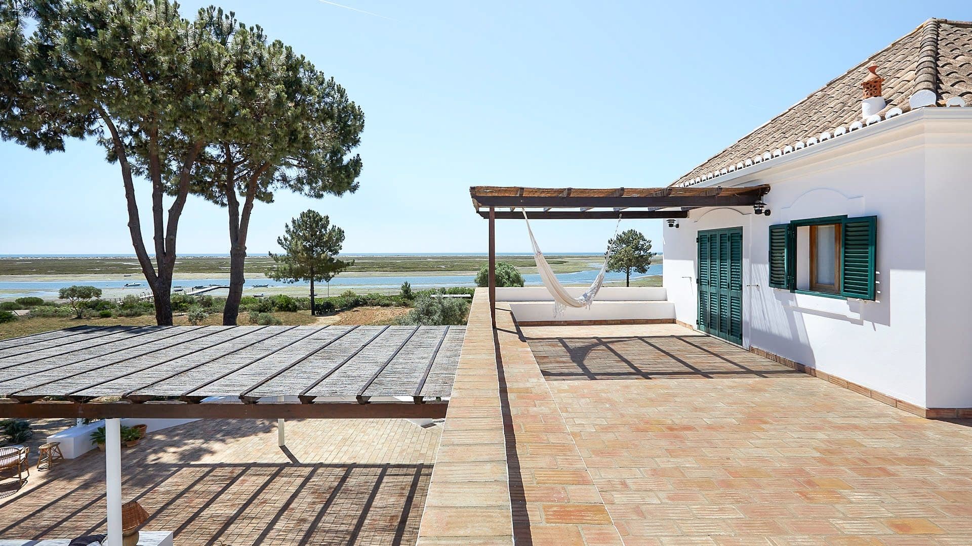Wooden deck with a hammock overlooking the Ria Formosa lagoon