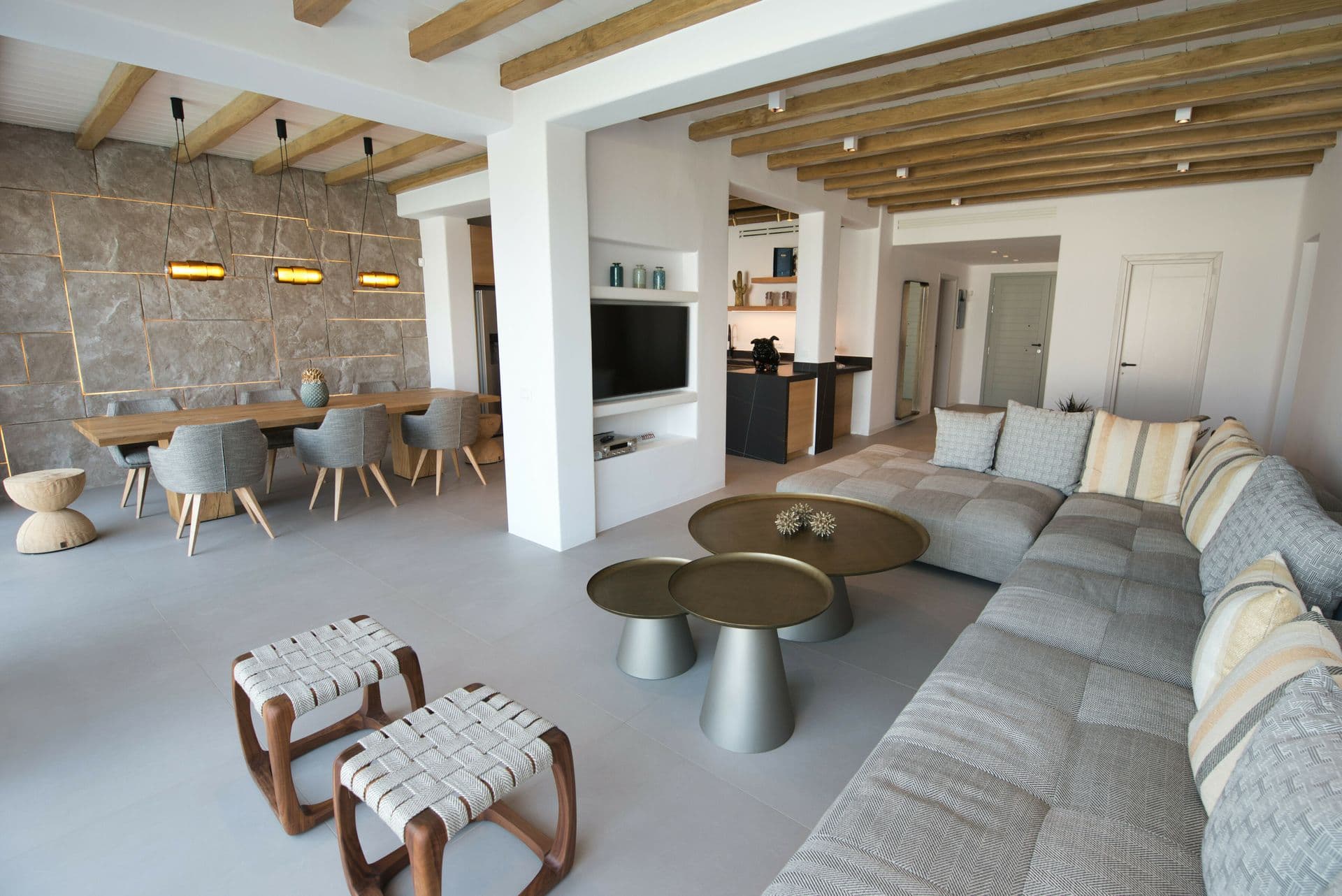 Open-plan living, dining and kitchen space under beamed ceilings at Cycladic Sunset Stay, Mykonos
