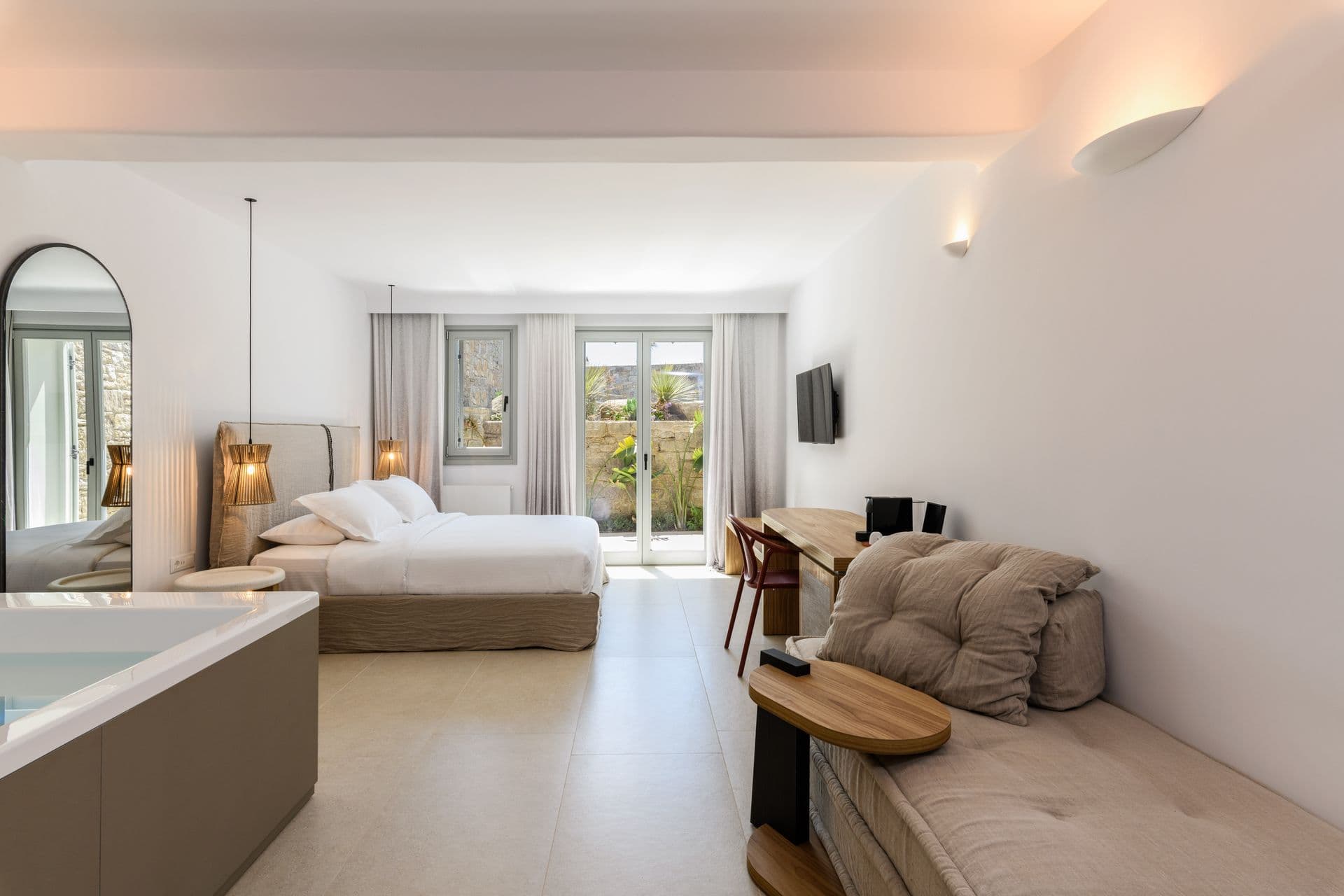 Master suite with a private jacuzzi, sitting area and sea view at Cycladic Sunset Stay, Mykonos