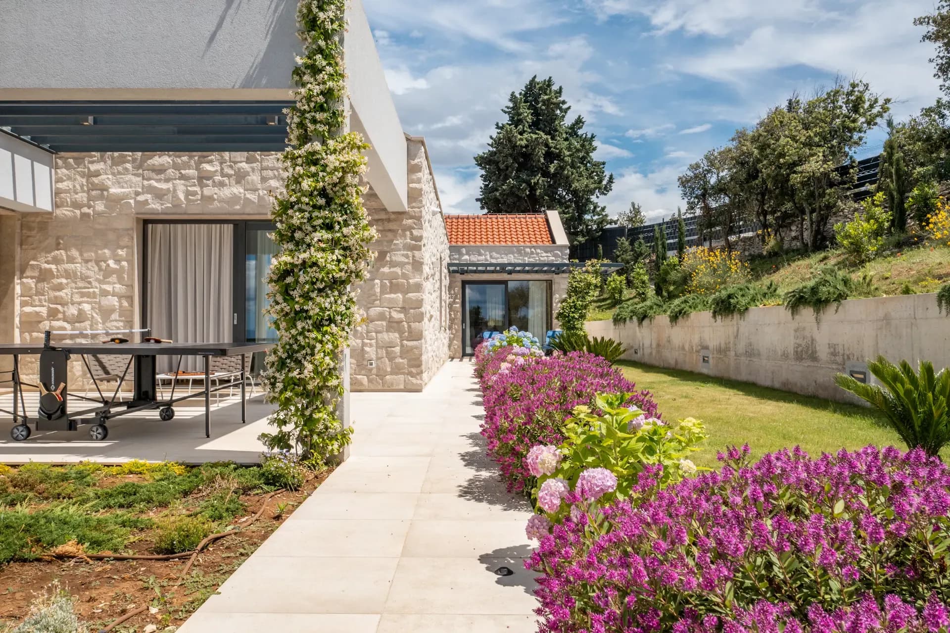 Flowering shrubs line the terrace steps at Highland Avenue.