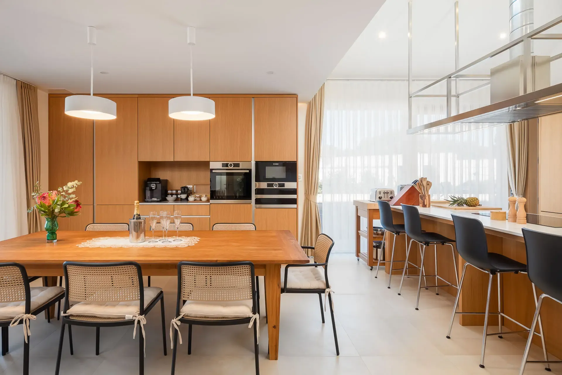 Kitchen island and bar seating at Highland Avenue, open to the dining area.