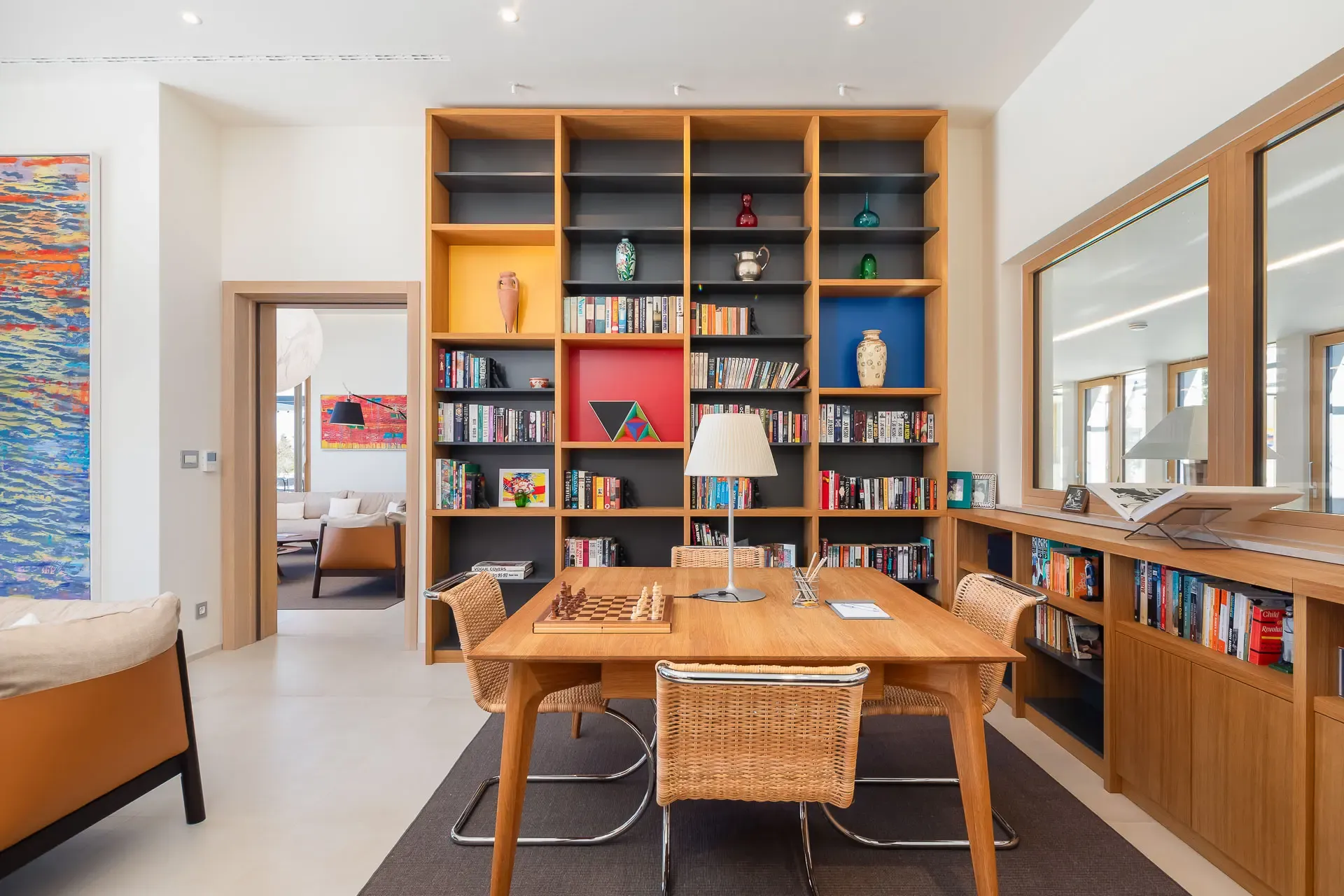 Library and informal dining nook at Highland Avenue, lined with bookshelves.