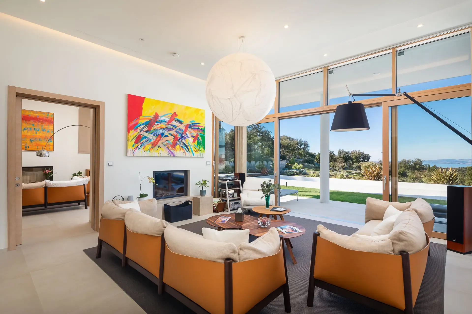 Open plan living space at Highland Avenue with floor to ceiling glazing and views over the garden.