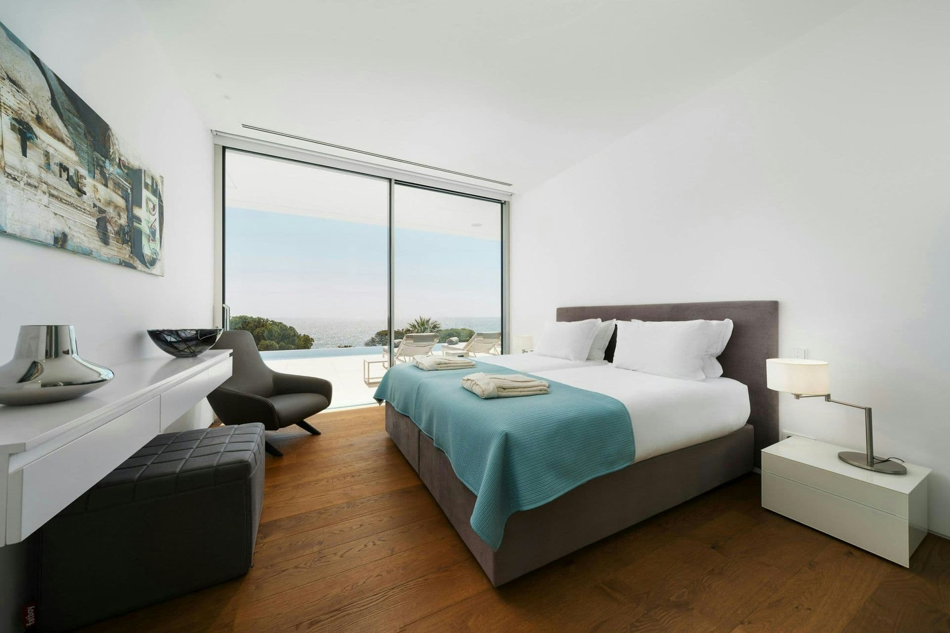 Double bedroom with a reading chair and sea view at A Coastal Crown, Lagos
