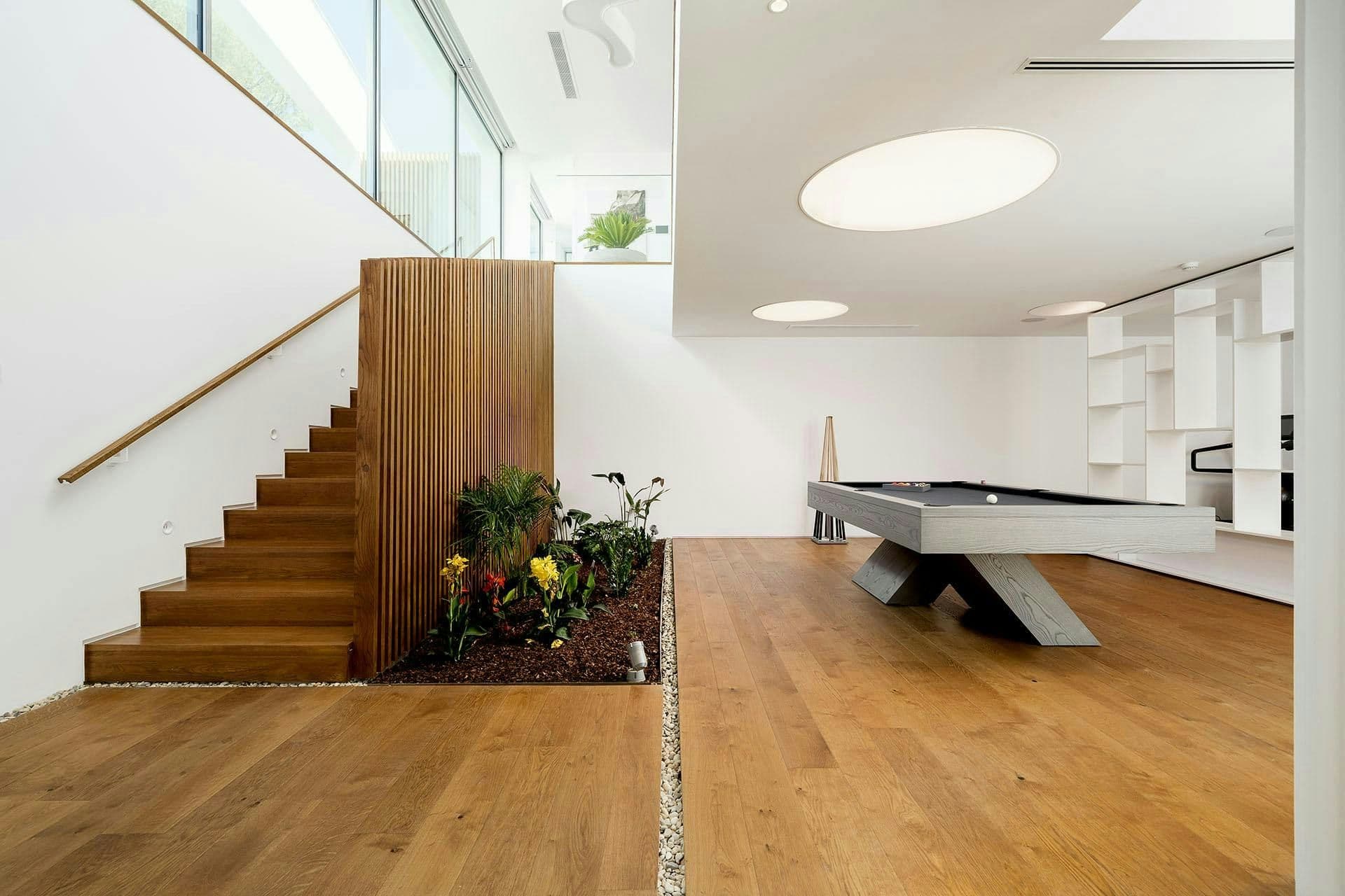 Games area with a pool table beside the staircase at A Coastal Crown, Lagos