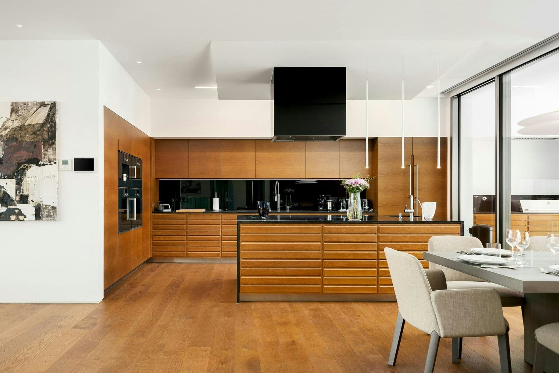 Sleek timber kitchen with an island at A Coastal Crown, Lagos