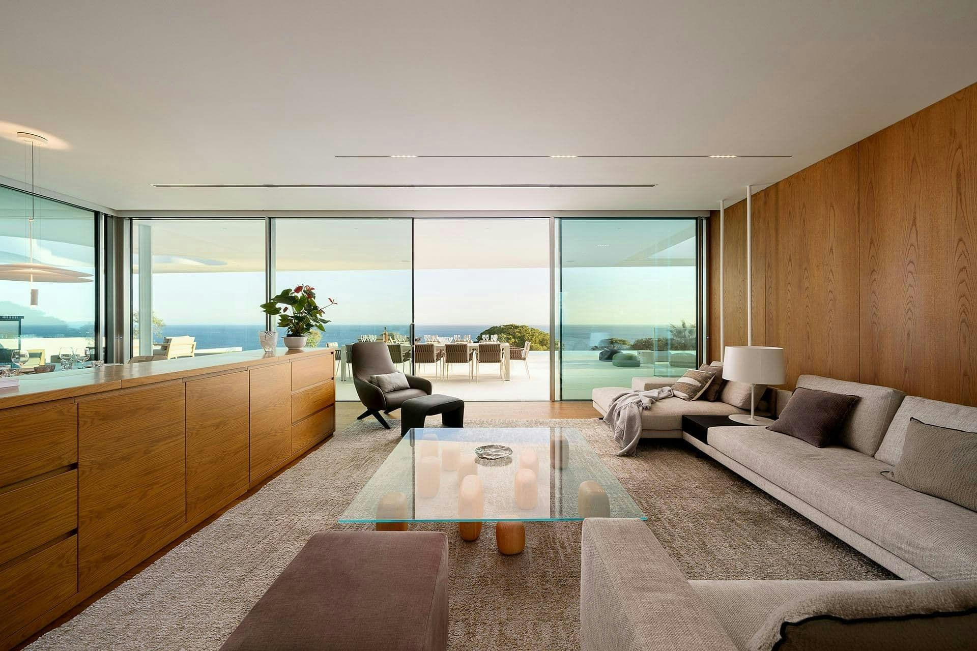 Living room with full-height glass and sea views at A Coastal Crown, Lagos