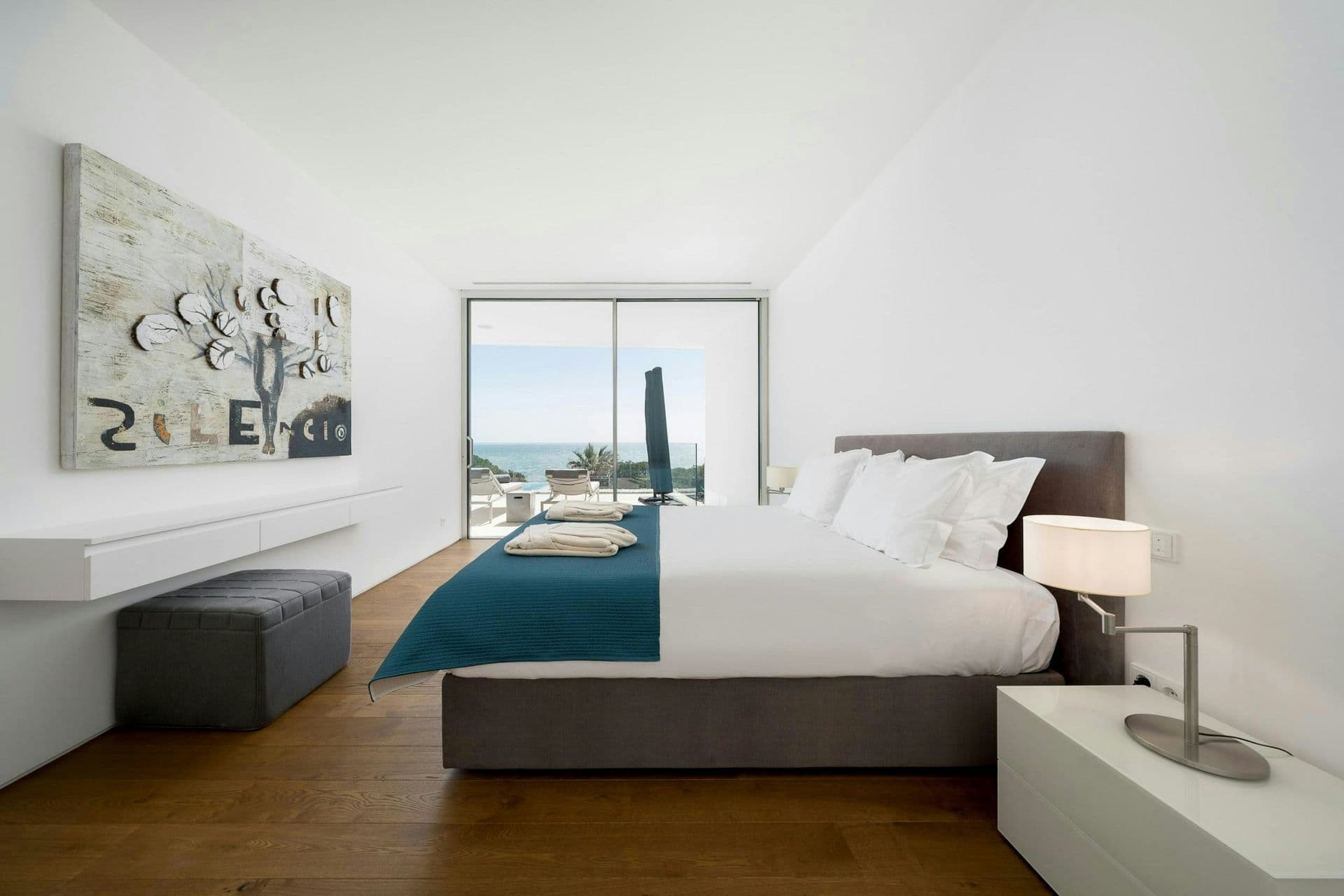 Master bedroom opening to a sea-view terrace at A Coastal Crown, Lagos