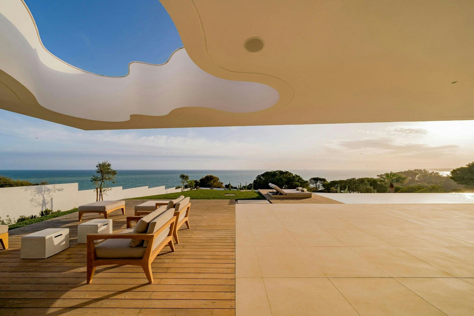 Terrace lounge seating overlooking the sea at dusk at A Coastal Crown, Lagos