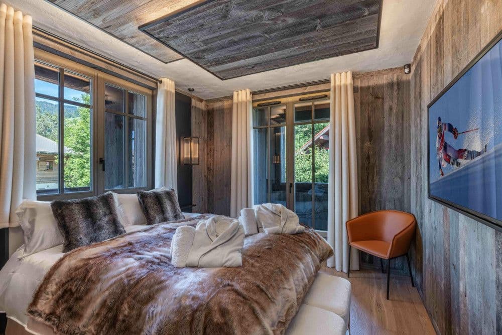 Double bedroom in old timber with ski artwork at Megeve Centre 7