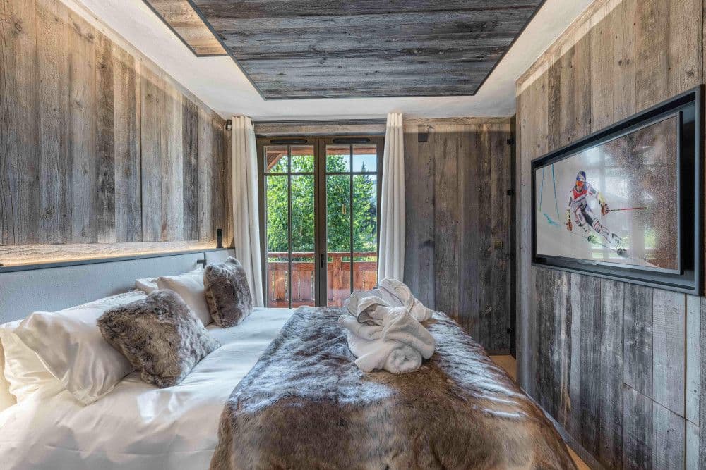 Guest bedroom panelled in weathered timber at Megeve Centre 7