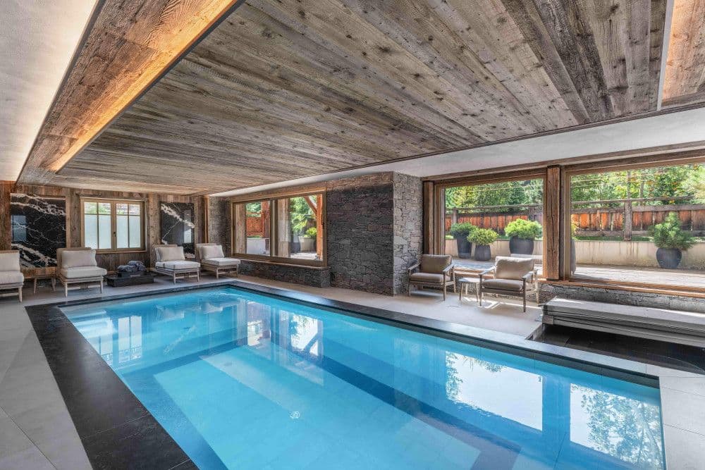 Indoor swimming pool opening to the garden at Megeve Centre 7