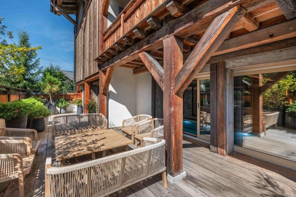 Outdoor terrace dining beside the pool and garden at Megeve Centre 7