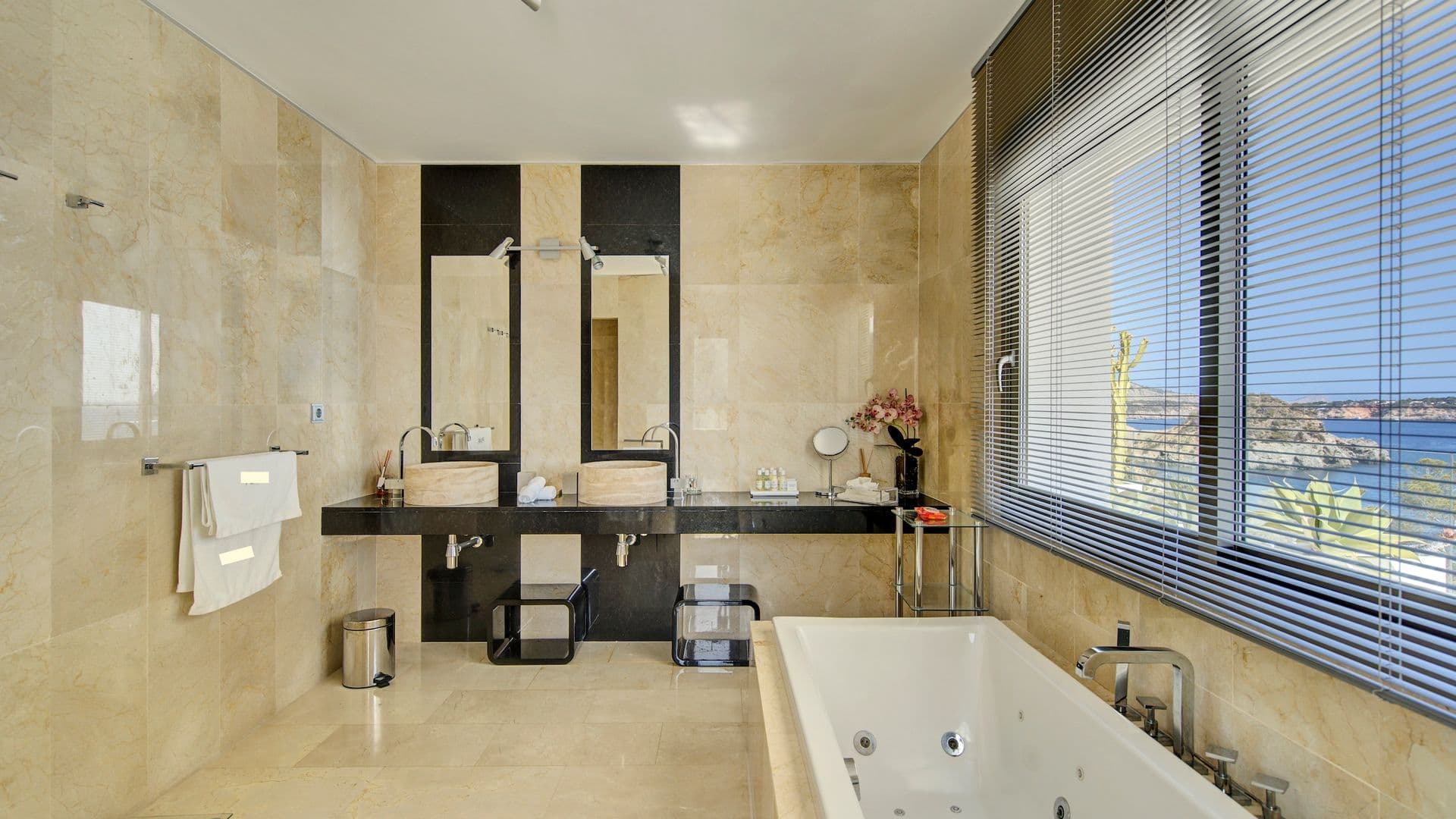 Travertine stone bathroom with double vanity and built in tub