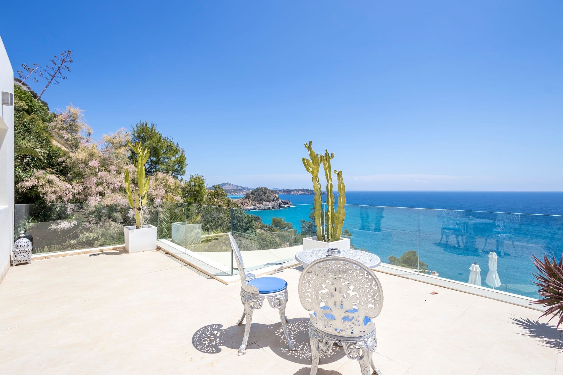 Terrace seating area with agave planting and panoramic sea views