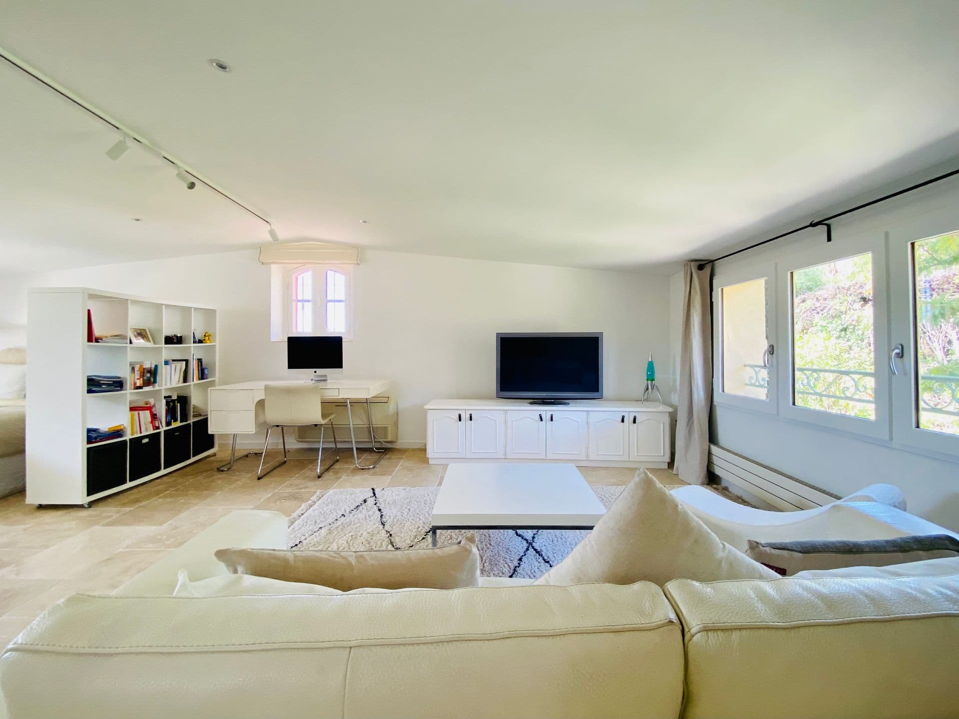 Living room with a built-in bookshelf and neutral upholstered seating.