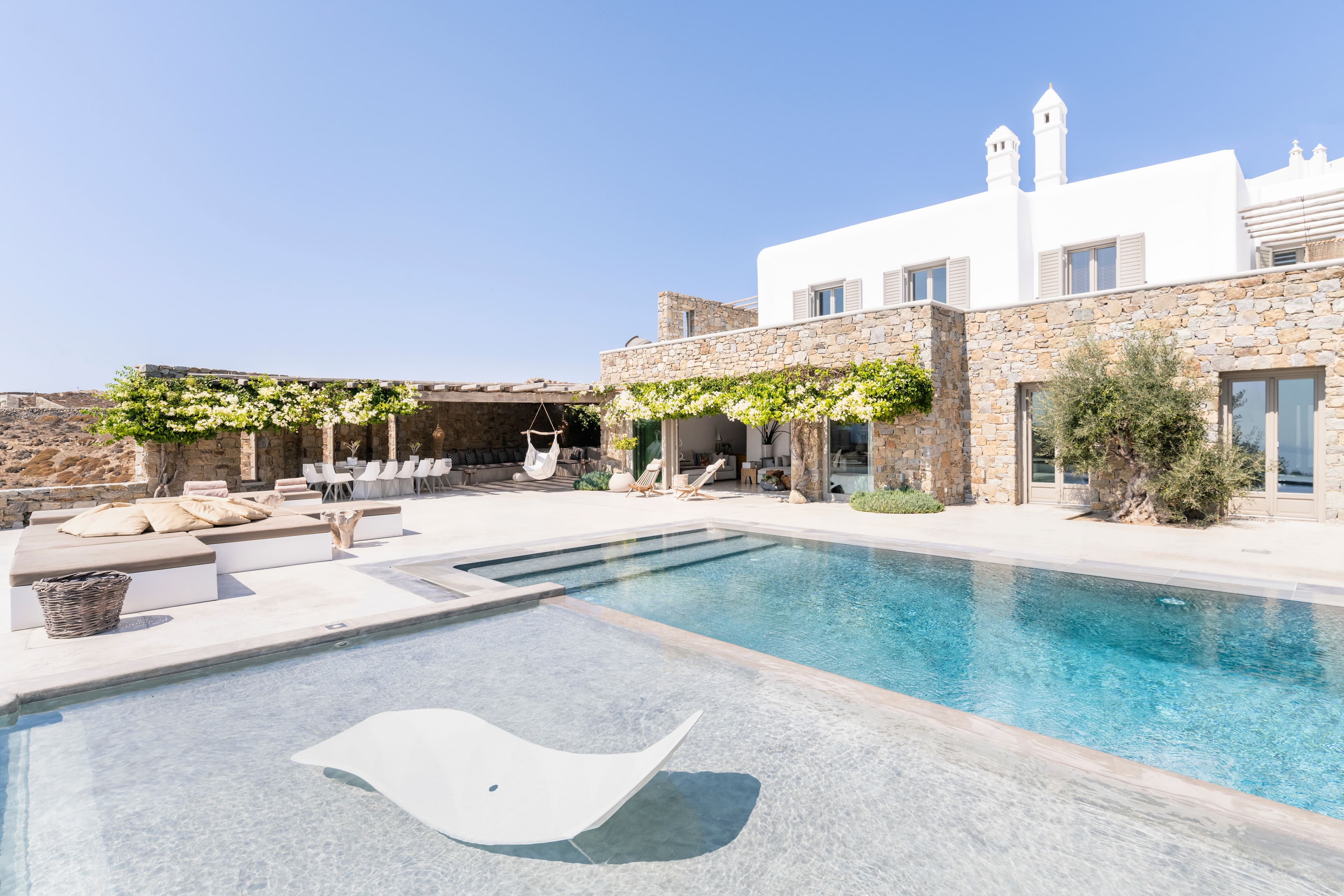 Villa Iliada pool terrace with Cycladic architecture and Mediterranean gardens, Mykonos, Greece