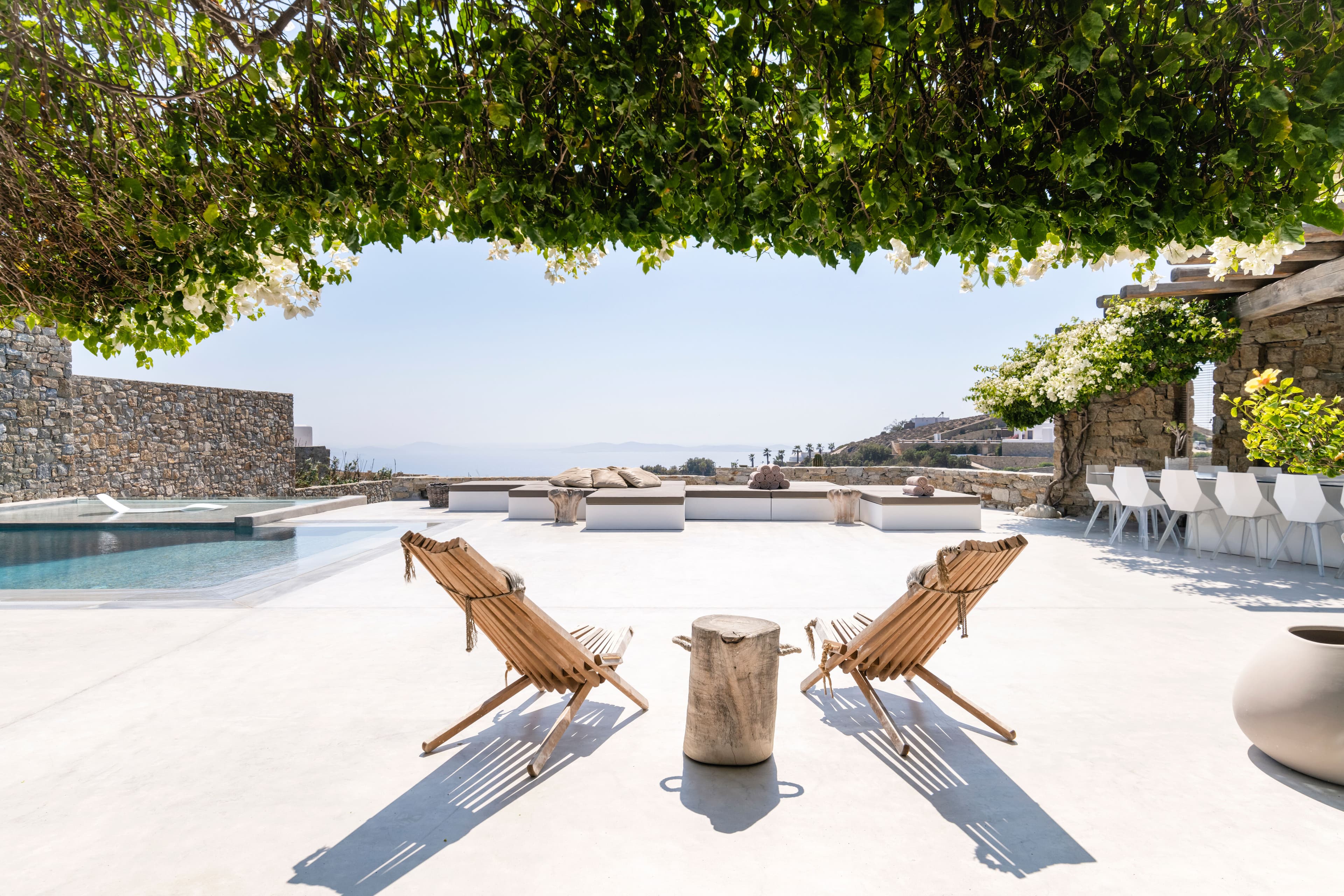 Villa Iliada shaded terrace with bougainvillea and outdoor lounge, Mykonos, Greece